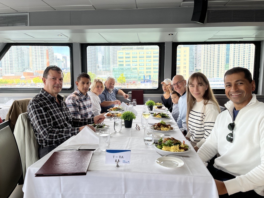 a group of people sitting at a table with food on it